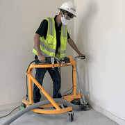 Operator edge grinding along a wall with the TC-7 and dust hose