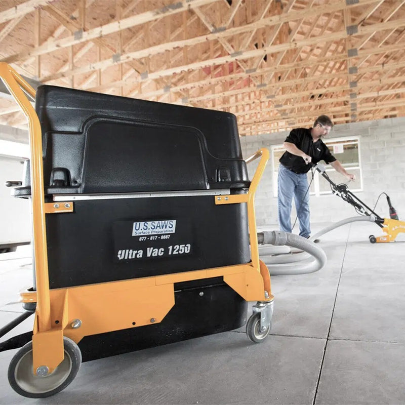 Operator with the Ultra Vac 1250 and a walk-behind saw on an interior slab