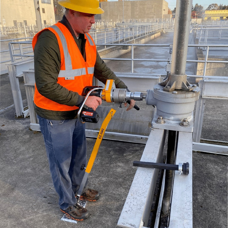 Operator exercising a plant valve with the maintenance kit at a treatment basin