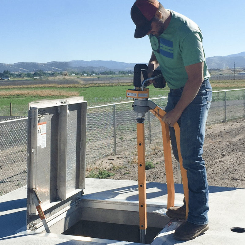 Operator running the VEX-400 on a valve box beside a rural road